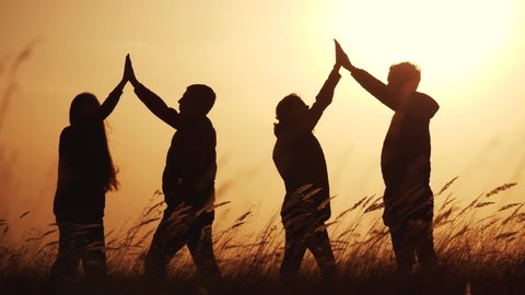 teamwork. team of tourists greet each other rejoice in success silhouette. business teamwork a travel tourism concept. group of people clap each other symbol success team of victory