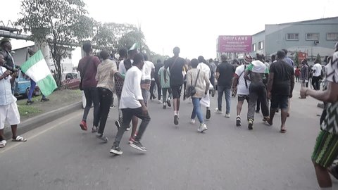 Port Harcourt, Nigeria - October 20, 2020:  #Endsars protesters performing stunts on the street at the location of the protest.