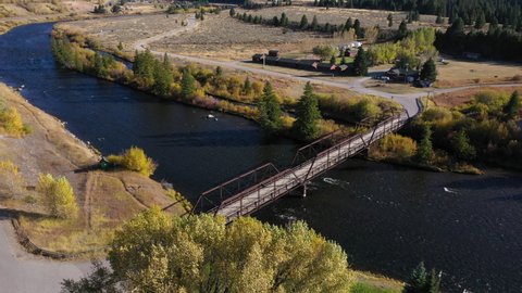 Aerial overhead Montana Madison River bridge rv campground 4K. Beautiful mountain river in Teton and Yellowstone areas of Montana and Wyoming. Recreation for rafting, world class fishing.