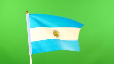 Flag of Argentina on flagpole on green background. Argentinian Flag waving in wind. Chroma key.