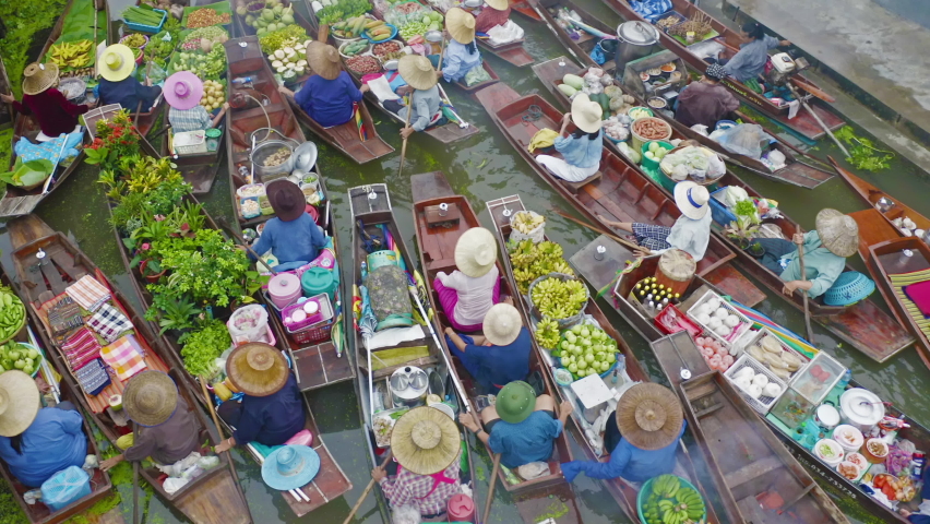 Damnoen Saduak Floating Market or Amphawa. Local people sell fruits, traditional food on boats in canal, Ratchaburi District, Thailand. Famous Asian tourist attraction destination. Festival in Asia.