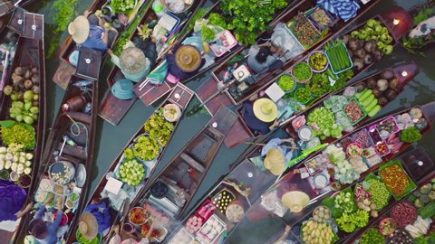 Damnoen Saduak Floating Market or Amphawa. Local people sell fruits, traditional food on boats in canal, Ratchaburi District, Thailand. Famous Asian tourist attraction destination. Festival in Asia.