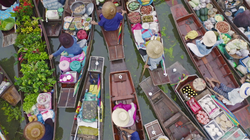 Damnoen Saduak Floating Market or Amphawa. Local people sell fruits, traditional food on boats in canal, Ratchaburi District, Thailand. Famous Asian tourist attraction destination. Festival in Asia.