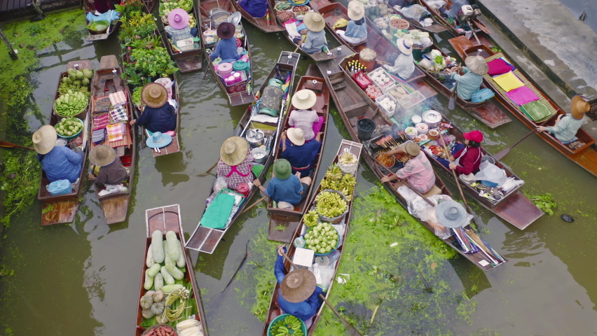 Damnoen Saduak Floating Market or Amphawa. Local people sell fruits, traditional food on boats in canal, Ratchaburi District, Thailand. Famous Asian tourist attraction destination. Festival in Asia.