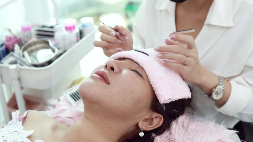 Close-up of clients' faces and eyebrows specialist, process of shaping and coating the eyebrows of women in a beauty salon, Professional queuing. Royalty-Free Stock Footage #1062653911