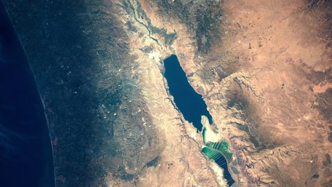 Satellite aerial view sunrise animation on Dead sea, salt lake in middle east area. Images furnished by Nasa