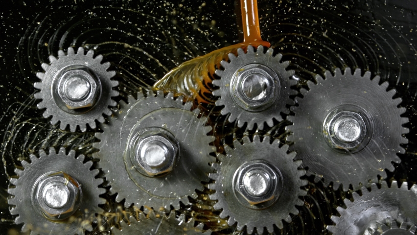 Super Slow Motion Shot of Gear Mechanism and Oil on Dark Background at 1000 fps. | Shutterstock HD Video #1062658690