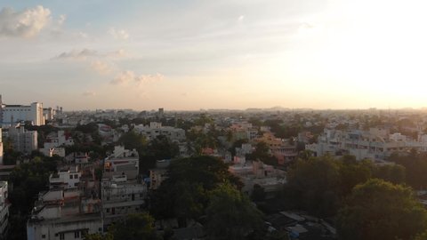 Aerial flyover shot showing the cityscape of Chennai City in India.Beautiful sunset in background.