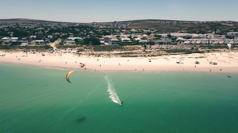 epic aerial Drone shot of Langebaan Beach, Cape Town, South Africa with paradise turquise ocean, beautiful beach and water sport kite sufing in frame. Pefrect summer vacation and holiday.