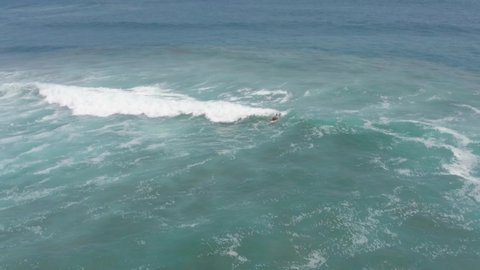 Acapulco / Mexico - 05 26 2019: Surfing on Pacific Ocean Waves, Surfers Near Coast, Aerial Pull Back View