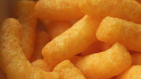 Cheesy corn puff snack extreme close up stock footage