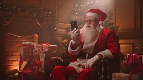 modern Santa Claus is using smartphone with internet for communicating, calling by video chat  - Powered by Shutterstock - Get 15% off with code: PIKWIZARD15