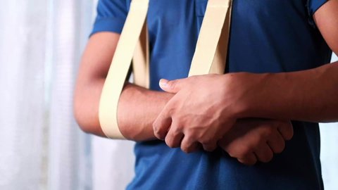 young man wearing an arm brace for broken hand .