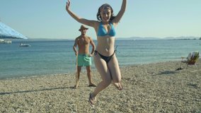 Jumping rope at the beach. Girl in bikini and her friends having fun while jumping rope outdoors on a sunny day.Slow motion video. - Powered by Shutterstock - Get 15% off with code: PIKWIZARD15