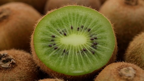 kiwi fruit. heap sliced and whole kiwi fruit close up