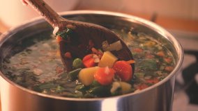 stirring a pot of vegetable soup close up. Minestrone soup boiling in the pot. Vegetarian healthy meal for dinner. Ready vegetable meal for lunch, hot and cozy soup for dinner at home - Powered by Shutterstock - Get 15% off with code: PIKWIZARD15