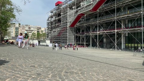 PARIS - CIRCA AUGUST, 2019: Footage of people walking in front of contemporary art museum called "Centre Pompidou" in Paris. It is a sunny summer day.