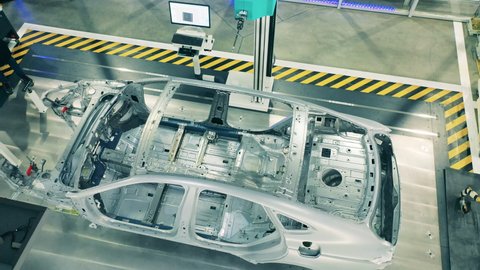 Top view of car body framework at car factory. Automotive factory equipment.