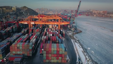 Flying around Vladivostok universal commercial sea port huge container terminal. Far East Russia transshipment of goods. International cargo transportation in Golden Horn Bay. Many colorful containers
