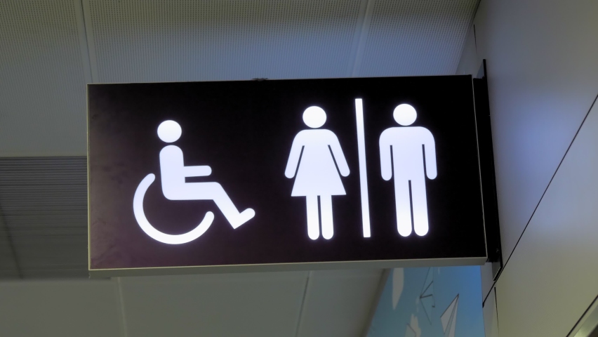 sign. pointer. toilet or WC. Signboard handicap toilet sign, toilet for people with disabilities. Female and male symbols on plates for public toilets, water closets. Pointer wc at the airport Royalty-Free Stock Footage #1062715621
