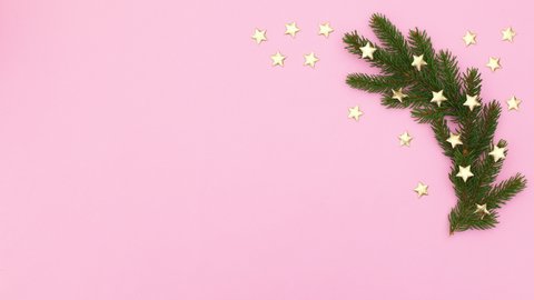 6k Christmas pine branches with gold stars on right side of pink theme. Stop motion