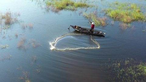 Aerial view from drone. Asian fishermen use traditional fishing nets in the lake in the morning.