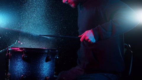 Super slow motion of drummer banging on cymbal and drum with water splashing. Filmed on high speed cinema camera , 1000 fps.