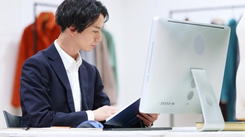 Young asian man working in modern office.