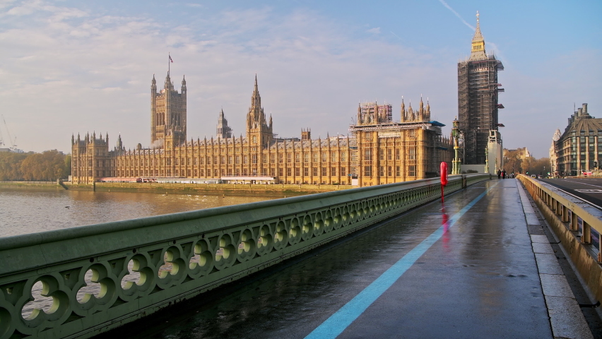 London in Coronavirus Covid-19 lockdown with empty quiet deserted streets with no people and no cars or traffic at rush hour at Westminster Bridge with Houses of Parliament and Big Ben in England, UK Royalty-Free Stock Footage #1062762106