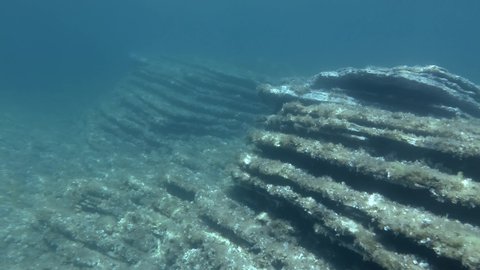 Layered rocky bottom of sedimentary rocks underwater. Geology of the seabed in the Adriatic Sea, Montenegro, Europe