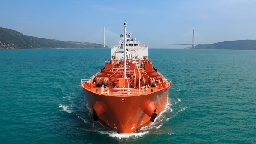 Bow and front deck of oil products tanker on ride. Supertanker loaded with full of oil underway in the open sea. Red prow, upper deck, pipe lines and winches of tanker ship cruising in ocean. Slow Mo. Royalty-Free Stock Footage #1062770368