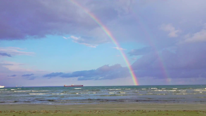 real rainbow by the ocean. multiple clips