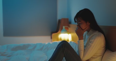 asian woman feel depressed in the bedroom at home