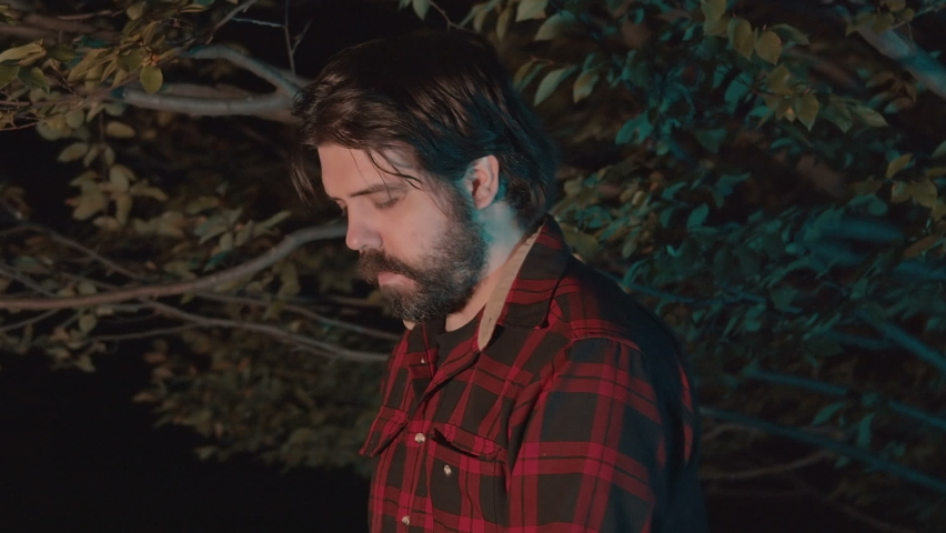 Lumberjack with a chainsaw at night