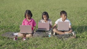 Kids smiling and learning on laptop outsite classroom in school
