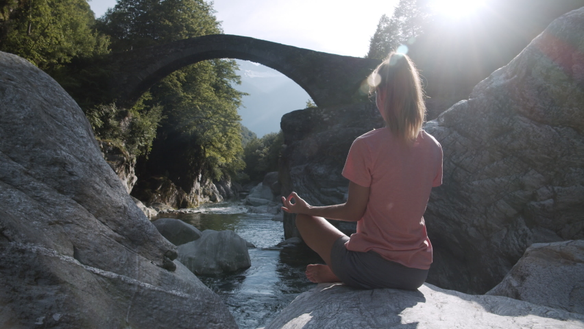 Young woman practicing meditation techniques in nature. Zen yoga meditation practice in nature. Slow motion  | Shutterstock HD Video #1062791197