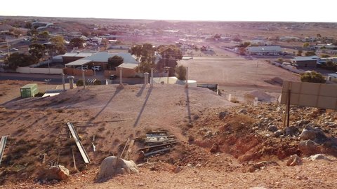 Night banner panorama of Coober Pedy opal mining town in Australia at twilight. Opal capital town of the world in South Australia. Breakaways Reserve