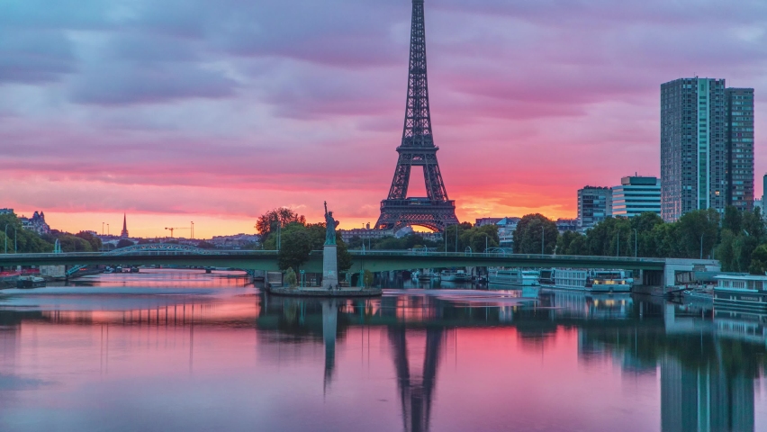 Eiffel Tower sunrise timelapse with boats on Seine river and in Paris, France. View from Mirabeau bridge. Modern buildings and The Statue of Liberty | Shutterstock HD Video #1062801382