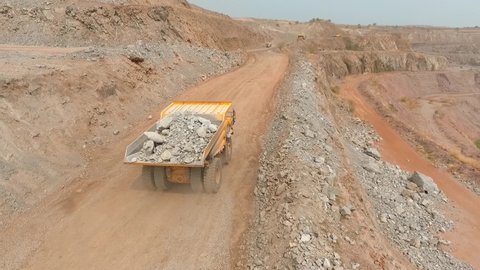 Africa, Angola. Huge trucks are working in the quarry. Open pit mining