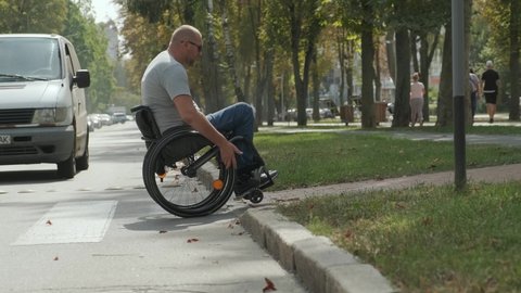 Person who uses a wheelchair, crossing street road