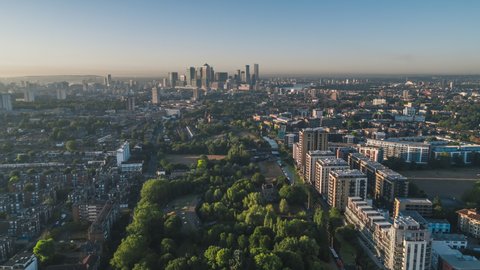 Aerial View Shot of London UK, Mile End Park & Financial District in the background, East London, United Kingdom, sunny day