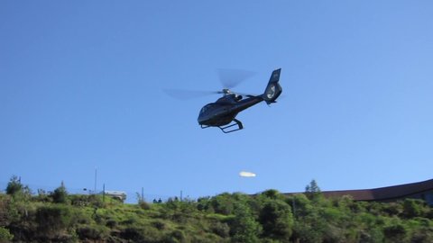 Knysna , Garden Route / South Africa - 05 18 2012: South African media helicopter lands on a hill during an auto race