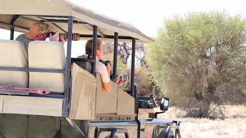Upington , Northern Cape / South Africa - 10 05 2016: Photo safari patrons take photographs from the specialized vehicle