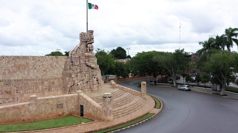 Aerial ascent and camera pitch down of the Monument a la Patria, Homeland Monument with Mexican flag on the Paseo de Montejo in Merida, Yucatan, Mexico