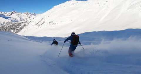 Two Professional skier skiing deep snow. Freeride skiing in Ischgl. Offpist with fresh snow on ski's. Ischgl Tirol Austria
