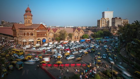 Time lapse view of rush hour traffic outside historical landmark Crawford Market in Mumbai, Maharashtra, India. 