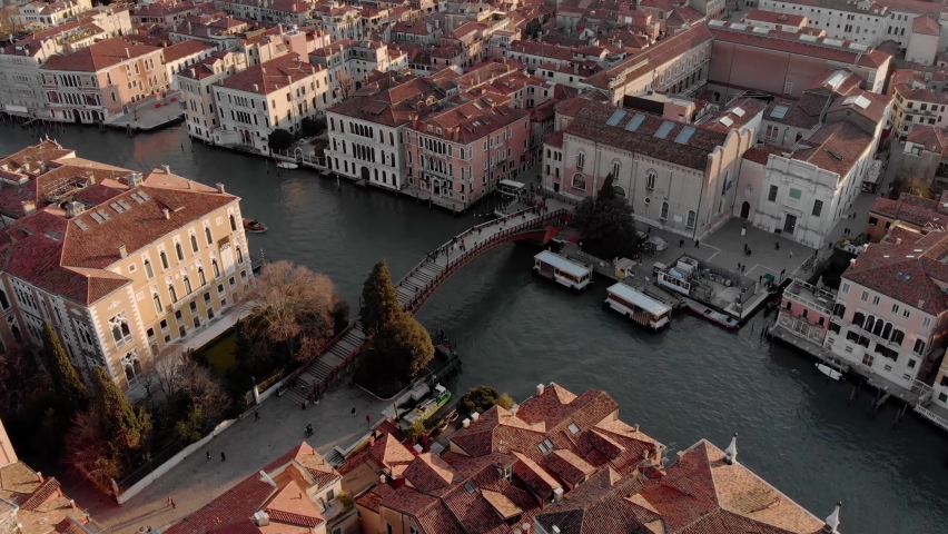 

Aerial view of the busy bridge near Venice. A drone panorama of the city overlooking the canal of the Adriatic Sea in northern Italy. A shot of people walking across the bridge from a drone. Sunset Royalty-Free Stock Footage #1062818743