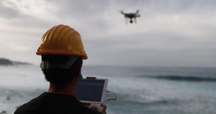 Man engineer flying with drone while wearing protective mask during coronavirus outbreak - Video surveillance and geology survey inspection concept