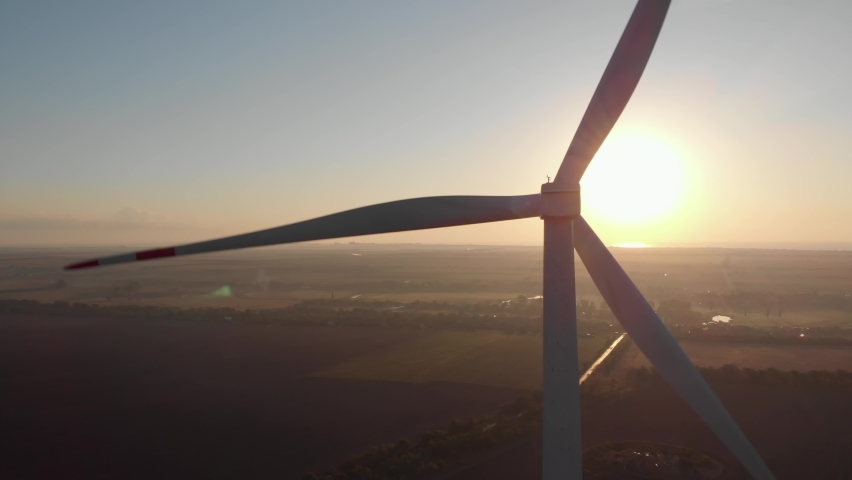 Dramatic close up detail of wind power turbine rotor blades backlight sunset beam rays. Renewable energy source windmill electric power production at golden hour flares. Cinematic green energy 4K | Shutterstock HD Video #1062822691