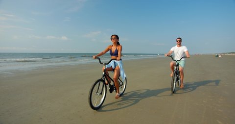 Happy Young Couple Biking on Beach, Slow Motion 4K